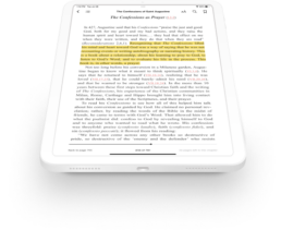 A tablet tilted at an angle displaying commentary from the ebook highlighted in yellow